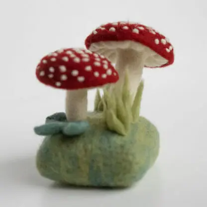 A side view of the forest toadstools needle felted sculpture.