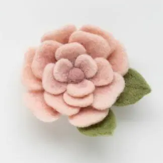 A kit to create a needle felted pink rose.