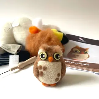 Observant Owl needle felting kit with completed brown owl featuring cream belly, orange beak, and yellow-green eyes.